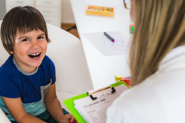 Child psychology, little boy talking to psychologist